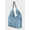 Denim bag decorated with fringe