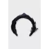 The black hoop is decorated with feathers