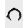 The black hoop is decorated with feathers