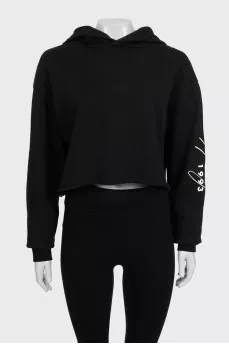 Black cropped hoodie with contrasting print on the sleeve
