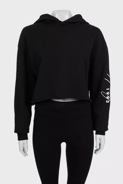 Black cropped hoodie with contrasting print on the sleeve