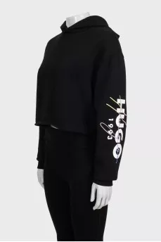 Black cropped hoodie with contrasting print on the sleeve