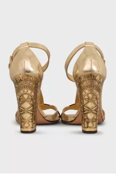 Gold heeled sandals with a 3D pattern
