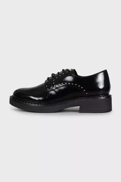 Black leather derby shoes with gold trim