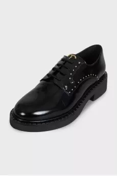 Black leather derby shoes with gold trim