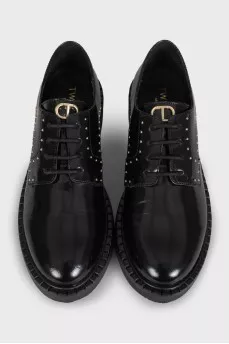 Black leather derby shoes with gold trim