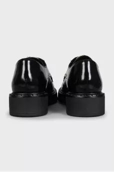 Black leather derby shoes with gold trim