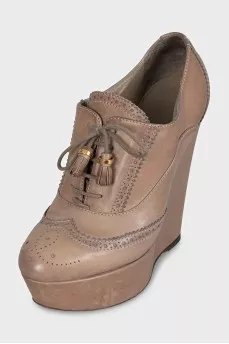 Leather ankle boots with a wedge heel and perforations