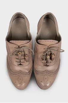 Leather ankle boots with a wedge heel and perforations