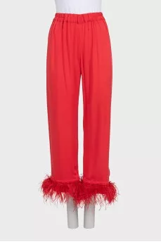 A suit with trousers decorated with feathers