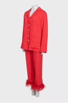 A suit with trousers decorated with feathers