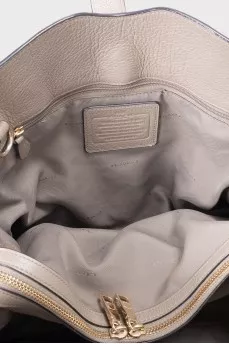 Gray leather tote bag with brand logo