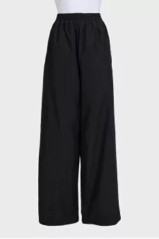 Black wide-leg trousers with elastic waistband and tag