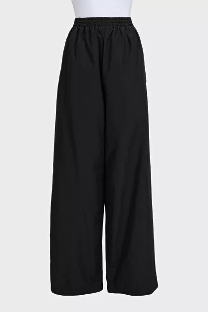 Black wide-leg trousers with elastic waistband and tag
