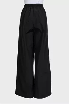 Black wide-leg trousers with elastic waistband and tag