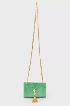 Green sued handbag with golden fittings, on the button
