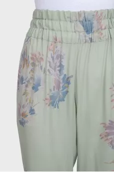 Green silk trousers with a floral print