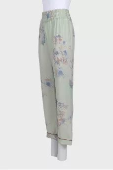 Green silk trousers with a floral print