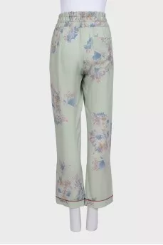 Green silk trousers with a floral print