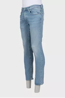 Men's light blue straight fit jeans with a button