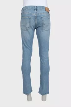 Men's light blue straight fit jeans with a button
