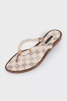Beige leather flip-flops with a print