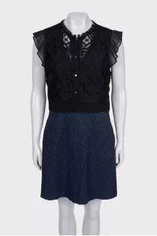 The blue and black dress is decorated with lace