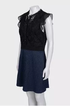 The blue and black dress is decorated with lace
