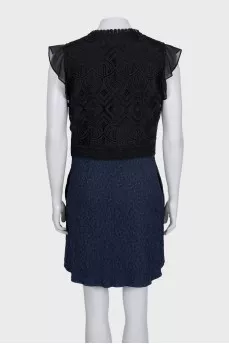 The blue and black dress is decorated with lace