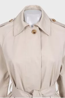 Beige trench coat with a buttoned belt