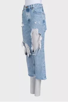 Blue distressed jeans with frayed edges
