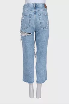 Blue distressed jeans with frayed edges