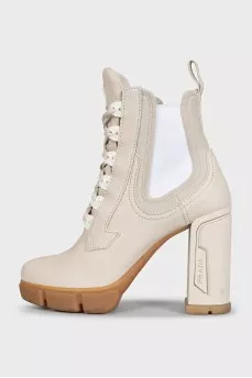 Leather ankle boots with heels and a logo on the heel