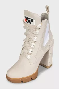 Leather ankle boots with heels and a logo on the heel