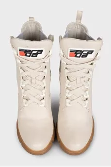 Leather ankle boots with heels and a logo on the heel