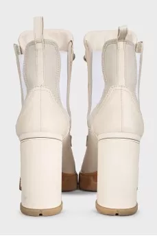 Leather ankle boots with heels and a logo on the heel