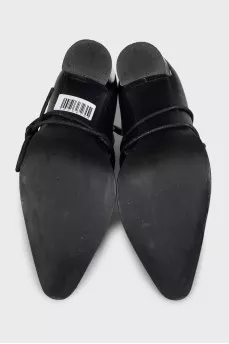 Black leather ankle boots with a pointed toe