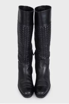 Black leather boots decorated with braiding