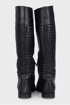 Black leather boots decorated with braiding