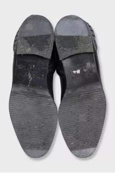 Black leather boots decorated with braiding