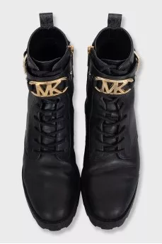 Black leather boots with gold-tone hardware