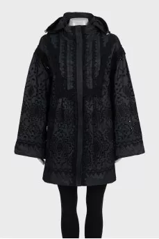 The black jacket is decorated with lace