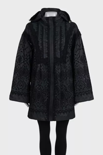 The black jacket is decorated with lace
