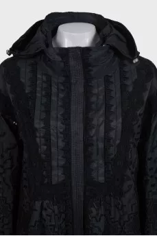 The black jacket is decorated with lace