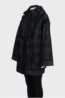 The black jacket is decorated with lace