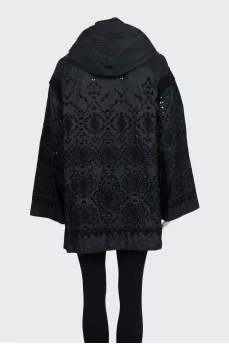 The black jacket is decorated with lace