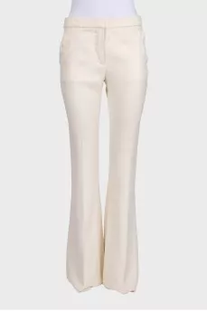 White high-waist flared trousers with creases
