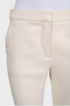 White high-waist flared trousers with creases
