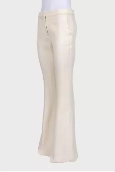 White high-waist flared trousers with creases