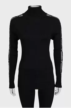 Black turtleneck with lace inserts on the sleeves